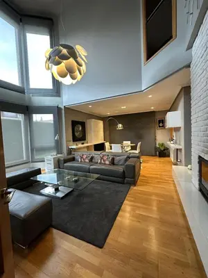 a living room with a glass table and white chairs at La Villa Allariz in Allariz