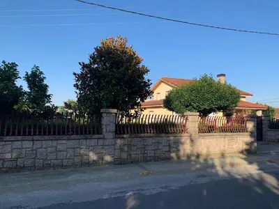 a stone fence in front of a house at Lar do Pero - Ribeira Sacra