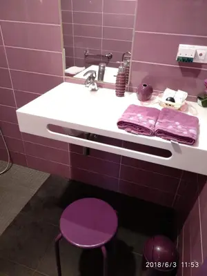 a purple bathroom with a sink and purple stools at Albergue Casa Cruceiro de Ferreiros in Ferreiros