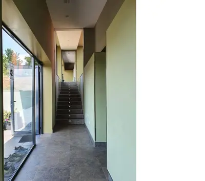 a hallway of a building with a stair case at Albergue Casa Cruceiro de Ferreiros in Ferreiros