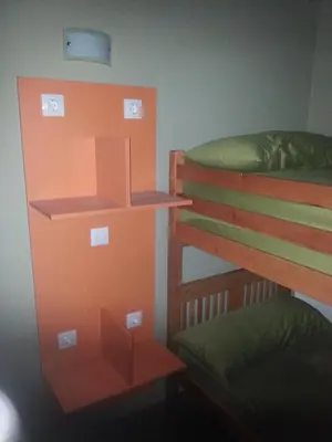 a bedroom with two bunk beds with lights on them at Albergue Casa Cruceiro de Ferreiros in Ferreiros