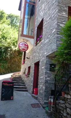 a brick building with a sign on the side of it at Casa Do Ferreiro - La Fragua in Las Herrerías