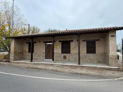a stone building on the side of a street at La Venta del Clavo in Astorga