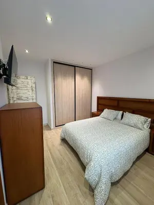 a bedroom with a bed and a television in it at La Venta del Clavo in Astorga