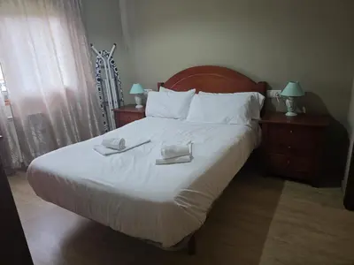 a bedroom with a large bed with two towels on it at Apartamentos Camino Inglés 3 in O Mesón Do Vento