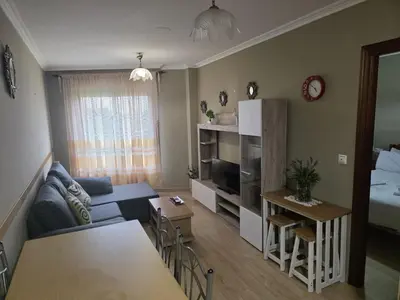 a living room with a couch and a table at Apartamentos Camino Inglés 3 in O Mesón Do Vento