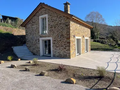 a stone house with lights on it at night at Casa Rural A Costa - Villa Rustica Asturias - Boal