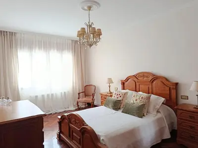 a bedroom with a bed and a fireplace at Casa Josefa in Villalba