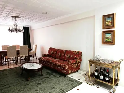 a bedroom with a bed with white sheets and a chandelier at Casa Josefa in Villalba
