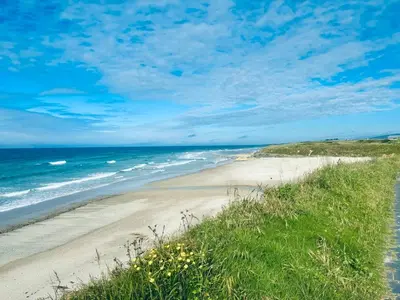 a sandy beach with the ocean in the background at Casa de Mia Beachfront Home Playa de las Catedrales Ribadeo in Pena