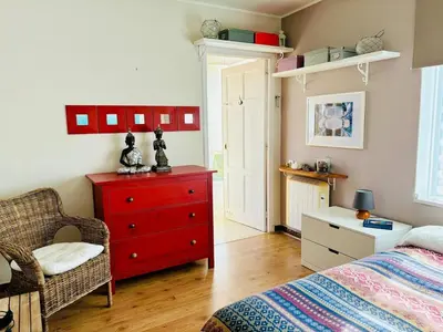 a bedroom with a red dresser and a red drawer at Casa de Mia Beachfront Home Playa de las Catedrales Ribadeo in Pena