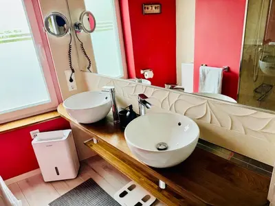 a bathroom with two sinks and a large mirror at Casa de Mia Beachfront Home Playa de las Catedrales Ribadeo in Pena