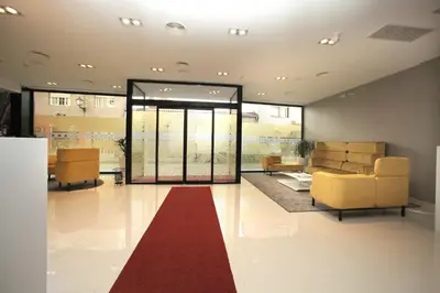 a lobby with couches and a red carpet at Hotel Cardenal in Monforte de Lemos