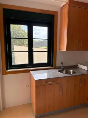 a kitchen with a sink and a window at El rincón de la Mariña in San Cosme de Barreiros