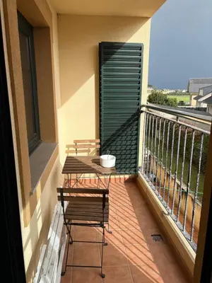 a balcony with two chairs and a table on a balcony at El rincón de la Mariña in San Cosme de Barreiros