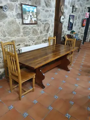 a stone building with two doors and a stone floor at Casa Dulcinea - casa rural en Ribeira Sacra in Serode