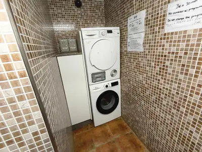 a bathroom with two sinks and a walk in shower at Albergue Val de Samos in Samos
