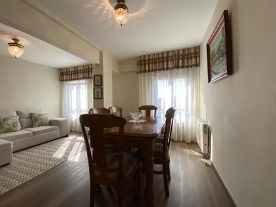a bedroom with a bunk bed with a green bedspread at Apartamento Cascallar in Caldas de Reis