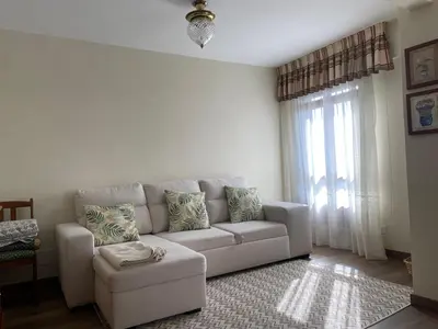 a living room with a couch and a chair at Apartamento Cascallar in Caldas de Reis