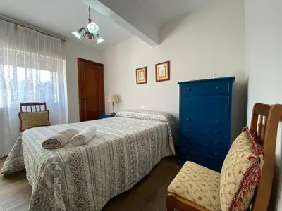 a bedroom with two beds and a blue dresser at Apartamento Cascallar in Caldas de Reis