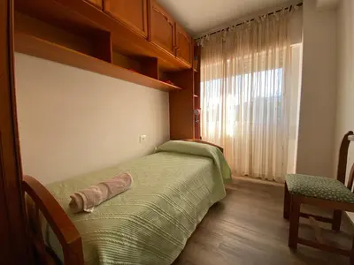 a bedroom with a large bed and a mirror at Apartamento Cascallar in Caldas de Reis