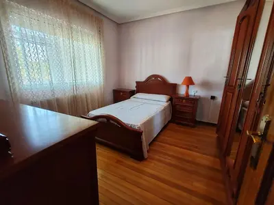 a living room with two beds and a window at Charming house & natural setting in Palas de Rei in Palas de Rei