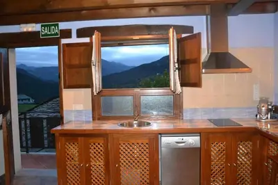 a kitchen with a sink and a window with a view at Apartamento La Casa del Abuelo Justo in Miñagón
