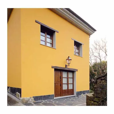 a yellow house with a door and two windows at Apartamento La Casa del Abuelo Justo in Miñagón
