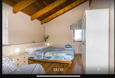 a bedroom with a bed and a chair at Casa Rural Ucedo in Ucedo