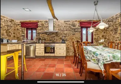 a kitchen and dining room with a table and chairs at Casa Rural Ucedo in Ucedo