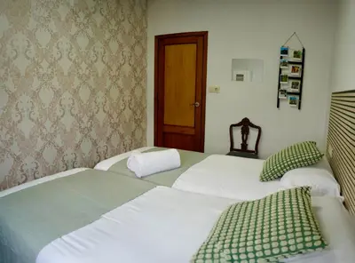 two beds sitting next to each other in a bedroom at Apartamentos Campus Arzúa in Arzúa