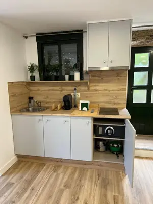 a kitchen with white cabinets and a sink at Alojamientos as moras arans in La Cañiza