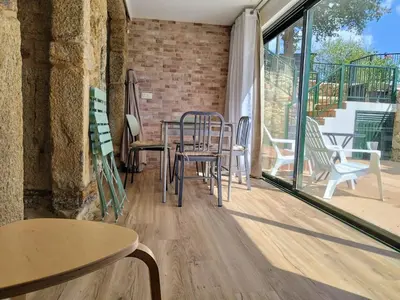 a patio with tables and chairs on a balcony at Alojamientos as moras arans in La Cañiza