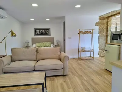 a living room with a couch and a table at Alojamientos as moras arans in La Cañiza