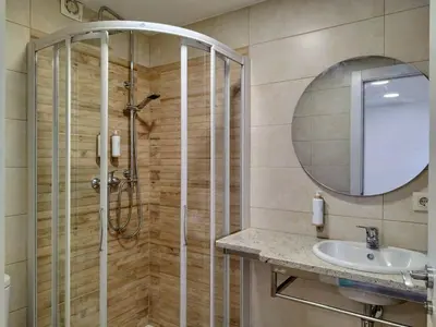 a bathroom with a shower and a sink and a mirror at Alojamiento cruceiro Arans in La Cañiza