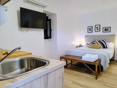 a kitchen with a sink and a bed in a room at Alojamiento cruceiro Arans in La Cañiza