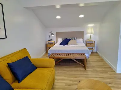 a bedroom with a bed and a couch at Alojamientos arans in La Cañiza