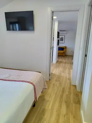 a bedroom with a bed and a television on a wall at Alojamientos arans in La Cañiza