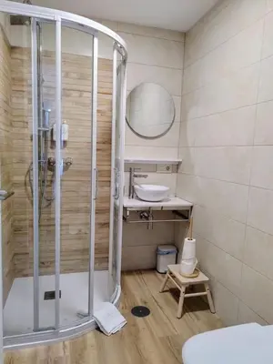 a bathroom with a shower and a sink at Alojamiento piñeiro arans in Oroso