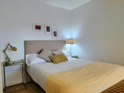 a bed with two pillows on it in a bedroom at Alojamiento piñeiro arans in Oroso