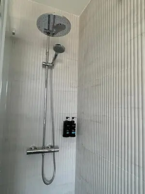 a shower with a shower head in a bathroom at VUT La CEPEDA in Astorga