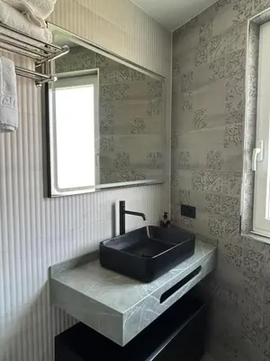 a bathroom with a black sink and a mirror at VUT La CEPEDA in Astorga