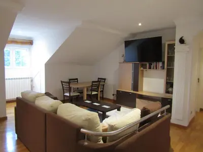 a living room with a couch and a table at Atico centrico Lela Lemos-3 habitaciones y 3 baños in Monforte de Lemos