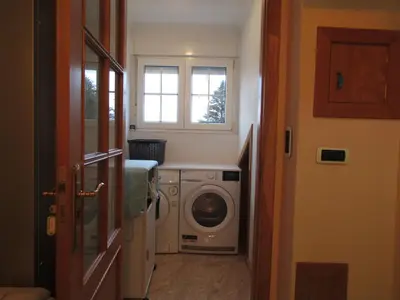 a laundry room with a washing machine and a window at Atico centrico Lela Lemos-3 habitaciones y 3 baños in Monforte de Lemos