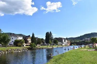a group of people swimming in a river at Apartamentos Picea Azul in Vega de Espinareda