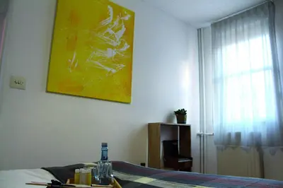 a room with a bed and a painting on the wall at MON ComeySueña Guesthouse in Monforte de Lemos