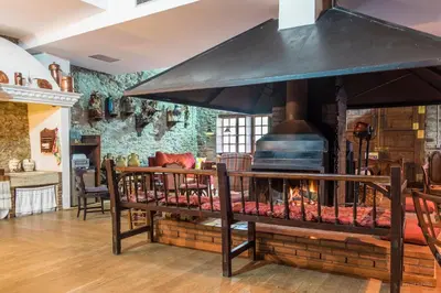 a large brick fireplace in a living room at La Casa Del Reloj in Molinaseca