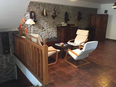 a living room with two chairs and a table at La Casa Del Reloj in Molinaseca