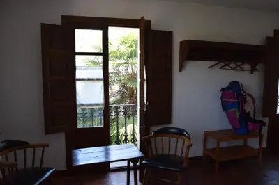 a room with a door and a table and chairs at La Casa Del Reloj in Molinaseca