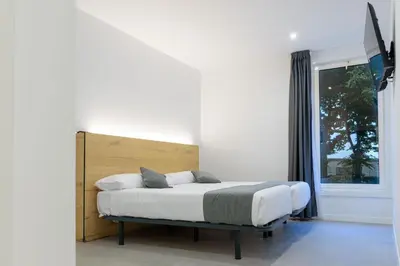 a bedroom with a bed and a window at Alda Palas de Rei in Palas de Rei